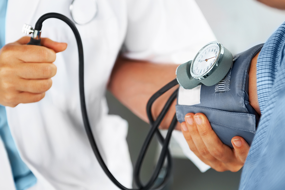 Patient having their blood pressure measured by a doctor.