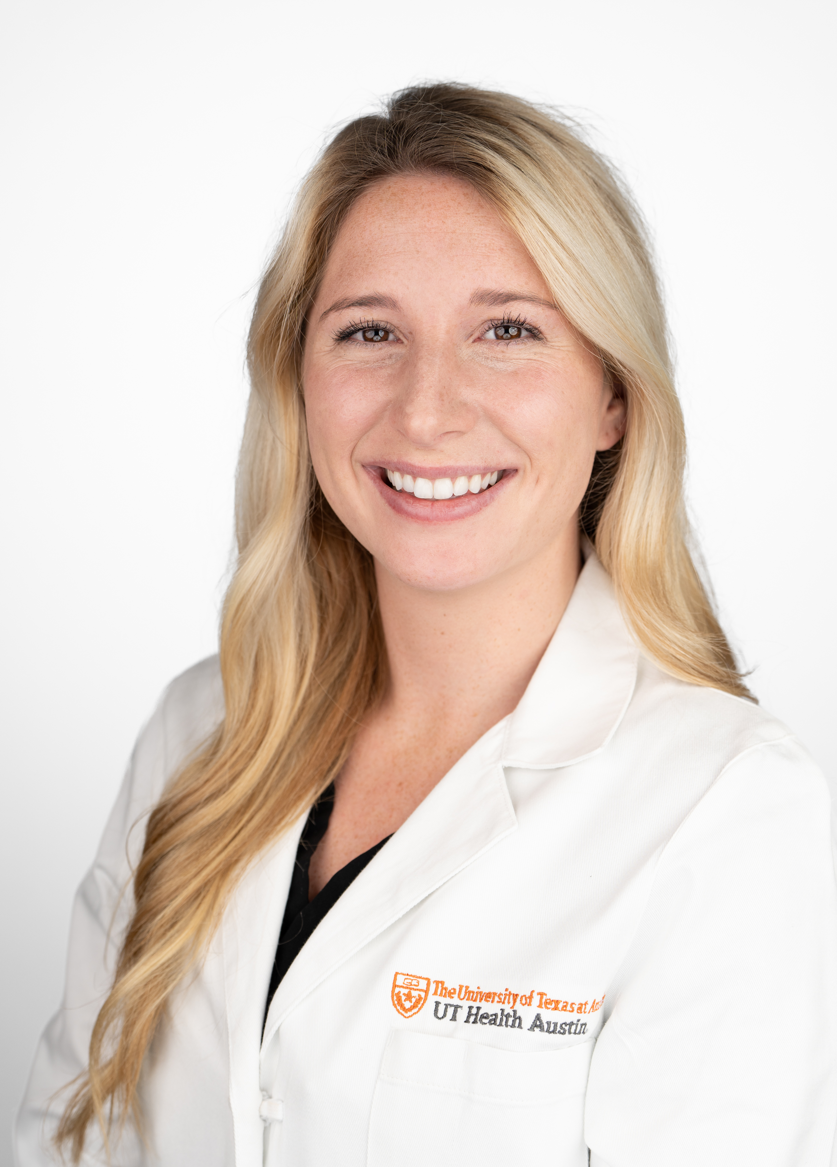 Physician assistant Daina Chase, PA-C, wearing a white coat and smiling in front of a white backdrop.