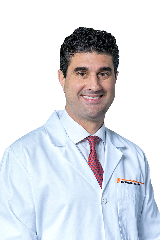 Dr. George Arnaoutakis wearing a white coat and smiling in front of a white backdrop.