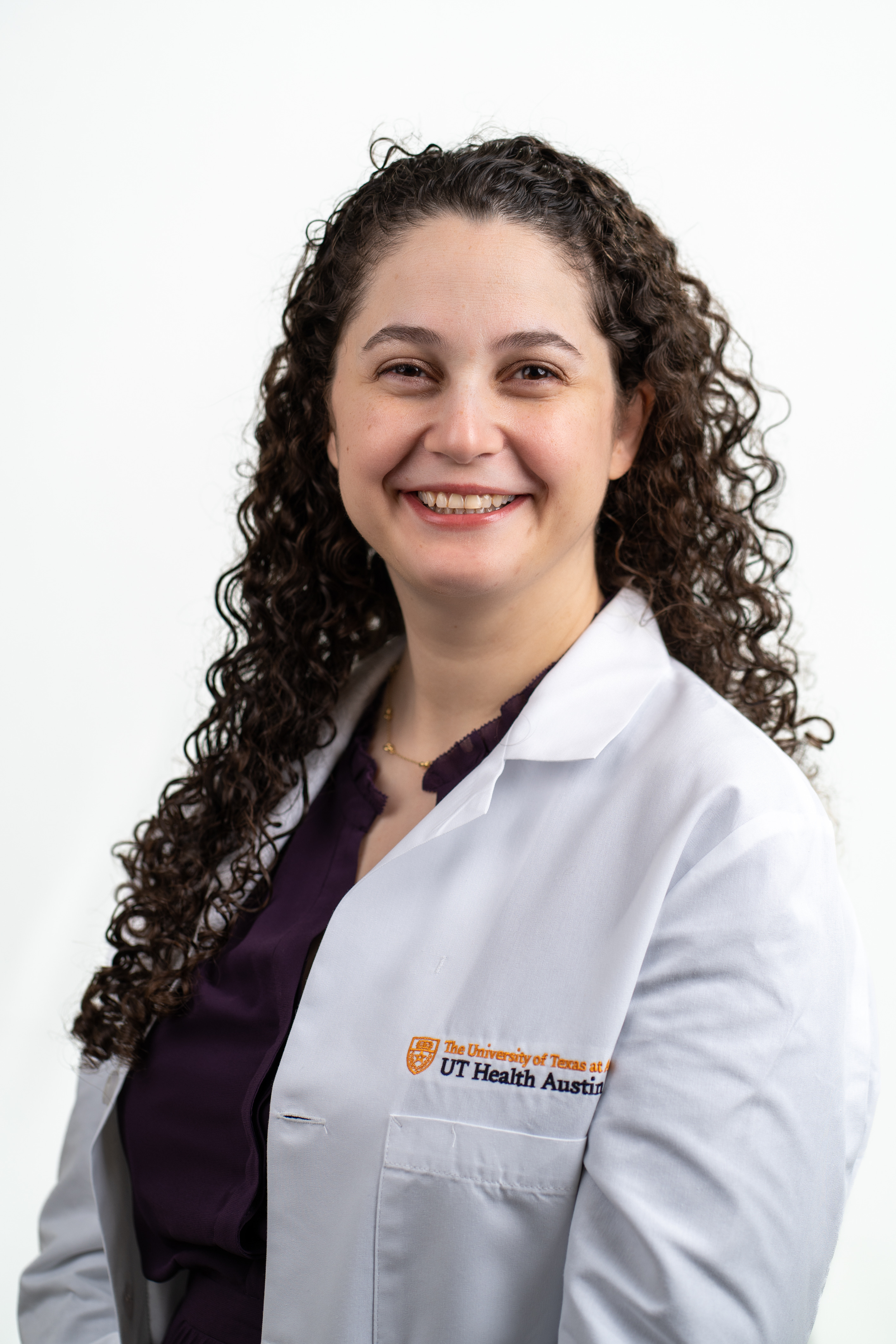 Pediatric advanced heart failure and transplantation physician Lauren D. Glass, MD, wearing a white coat and smiling in front of a white background.