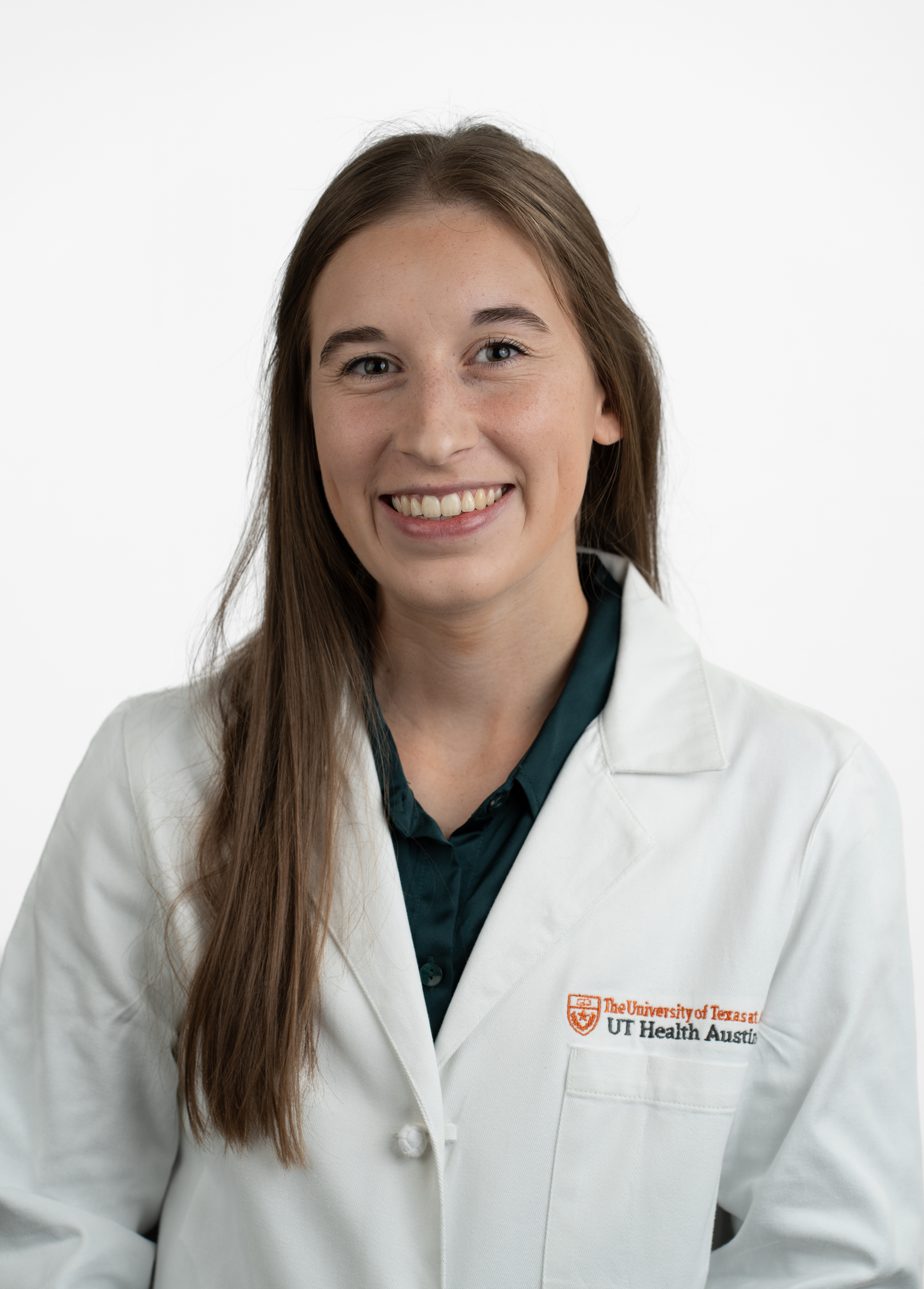 Physician assistant Lily Harvison, MSPAS, PA-C wearing a white coat and smiling in front of a white backdrop.