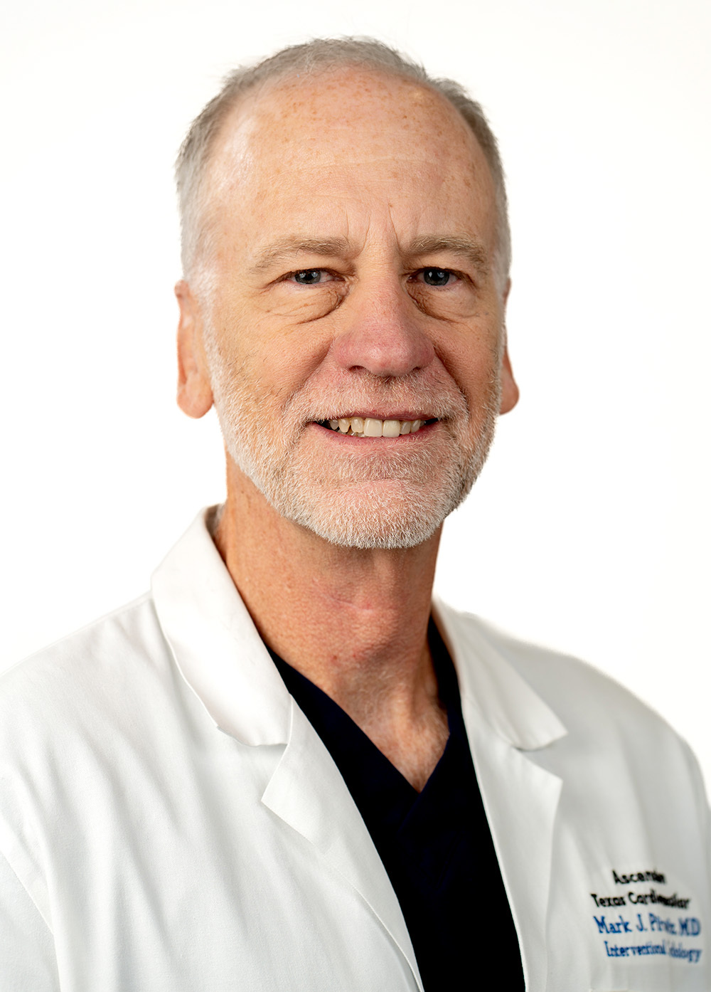 Cardiologist Mark Pirwitz, MD, FACC, wearing a white coat and smiling in front of a white background.