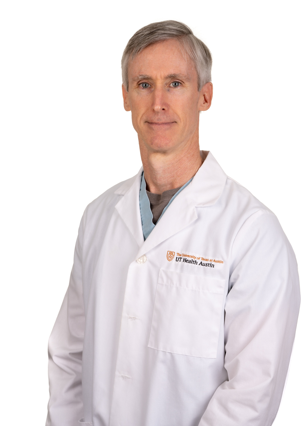 Dr. Michael J. Auth wearing a white coat and smiling in front of a white backdrop.