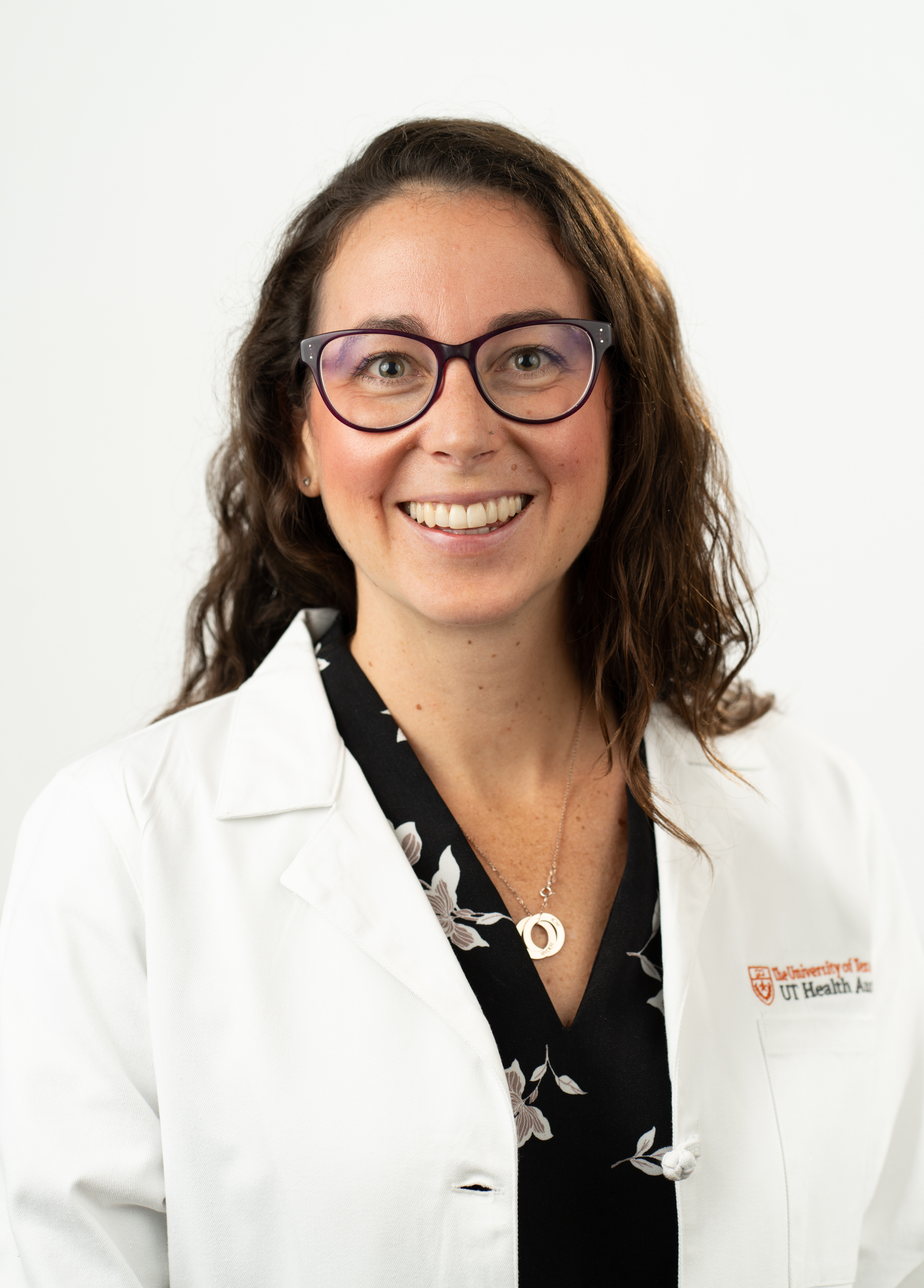 Samantha Irwin , MD stands in front of a white background smiling