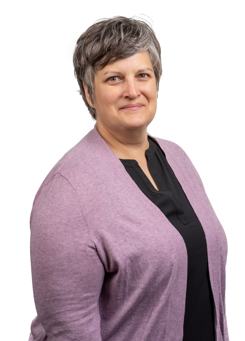 Dr. Lynn Thoreson wearing a lilac cardigan and smiling in front of a white backdrop.