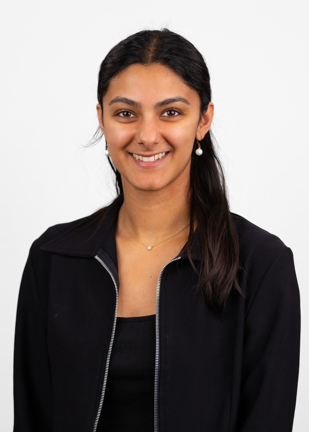 Headshot of Mahal Esha. She is wearing a black blouse and a black zippered jacket.
